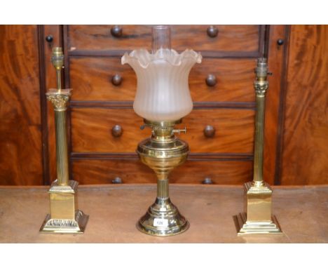 A 20th century brass Corinthian column table lamp, stepped square base; another, similar; a brass oil lamp converted to elect