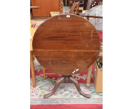 A George III mahogany tilt top tripod table, circular top, turned column, cabriole legs, pad feet (faults)