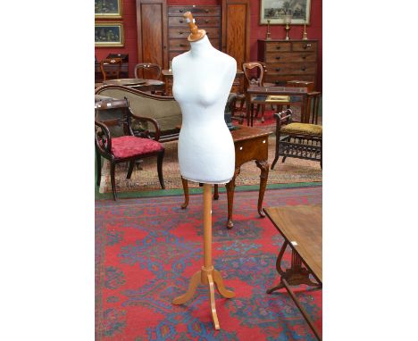 A shop display mannequin, female torso, tripod base