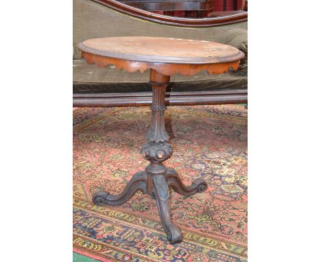 A Victorian walnut veneered tripod table, circular top, shaped apron, turned column, cabriole legs.