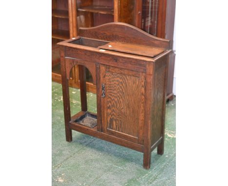 A 1920/30's oak hall/stick stand, galleried back, hinged cover to glove box over shelved cupboard. 98cm high x 79cm wide.