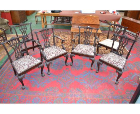 A set of six Chippendale style dining chairs including two carvers, shaped top rail, pierced vasular splat, drop in seat, cab