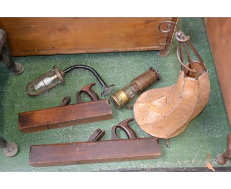 A miners lamp by Ackroyd and Bes, an industrial bulkhead lamp, a hide covered lamp and two woodworking planes 
