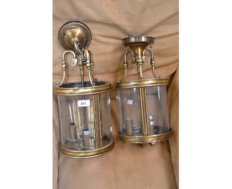 A pair of modern three light pendant lights