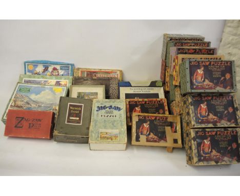 Travelling trunk containing a large collection of vintage wooden jigsaw puzzles by Victory and others, some in original boxes