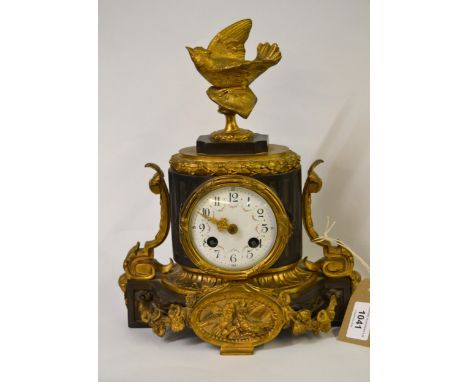 19th Century bronze and gilt metal mantel clock, surmounted with a figure of a bird having circular enamel dial with floral s