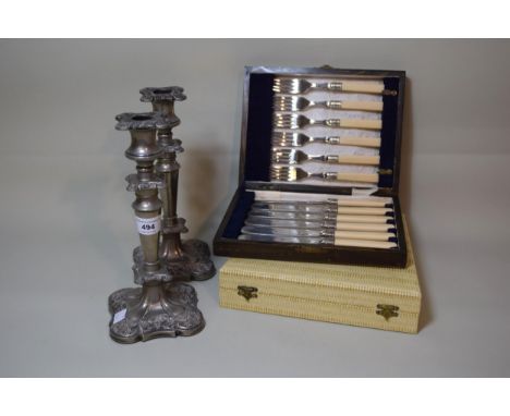 Pair of silver plated candlesticks and two cased sets of plated flatware 