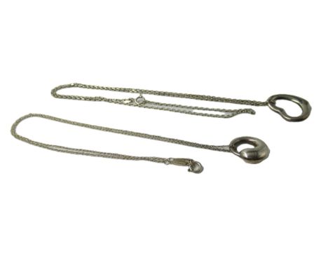 Tiffany silver heart shaped pendant and chain, together with a similar Tiffany pendant (chain not by Tiffany) 