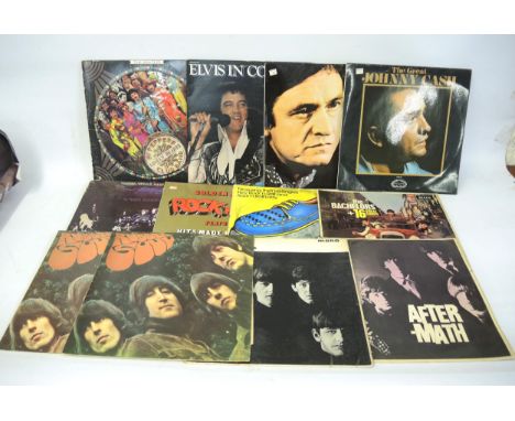 Three Beatles LP records, ' With The Beatles ' and two copies of ' Rubber Soul ', together with one copy The Rolling Stones, 