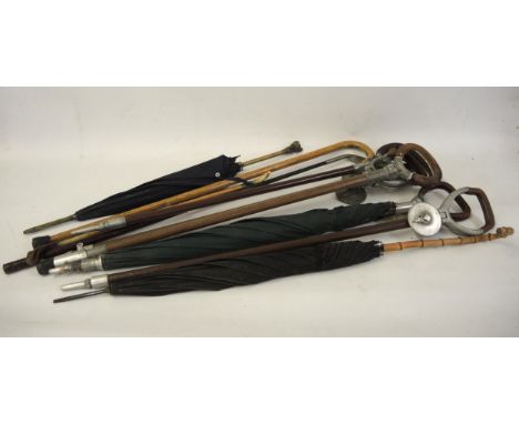 Vintage parasol with dogs head handle, together with a quantity of shooting sticks etc. 