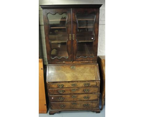Mid 18th Century mahogany bureau bookcase, the moulded cornice above a pair of glazed doors enclosing shelves, the base with 
