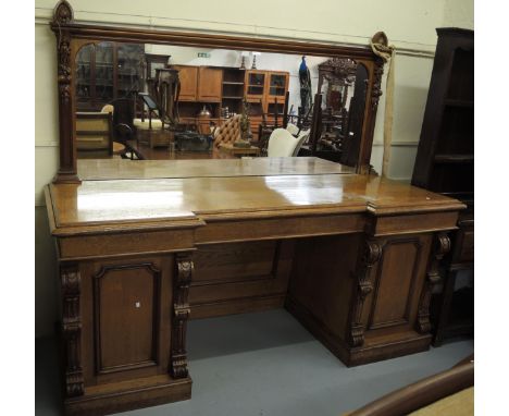 Large Victorian oak twin pedestal sideboard, the carved and moulded mirror back above an inverted breakfront base with three 