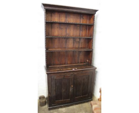 Early 20th Century stained pine dresser with a boarded shelf back above two rectangular panel doors, 214 x 118cm 