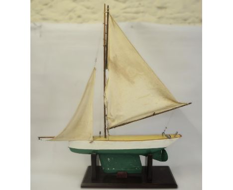 Small wooden model pond yacht on a stand with rigging 