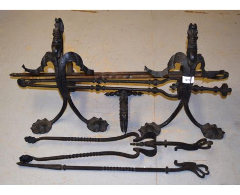 Pair of Arts and Crafts wrought iron fire dogs in the form of dragons, together with a quantity of fire tools 