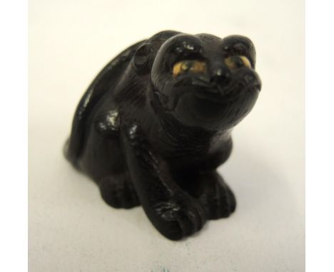 Japanese carved boxwood netsuke in the form of an animal, signed to the base 