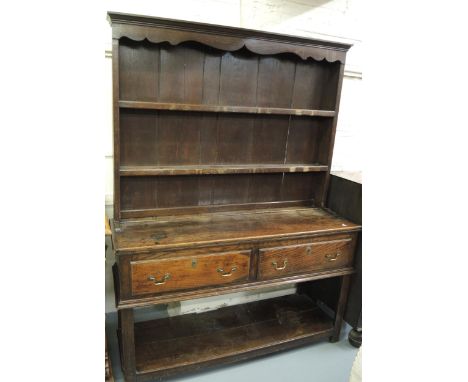 Small 18th Century oak dresser, the boarded shelf back above a plank top, two drawers, rectangular cut supports and undertier