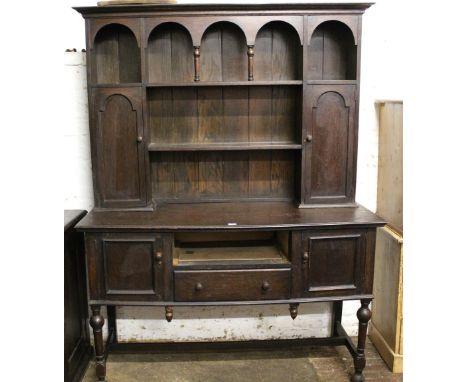 Early 20th Century oak dresser with a boarded shelf and cupboard back above drawers and cupboard doors 