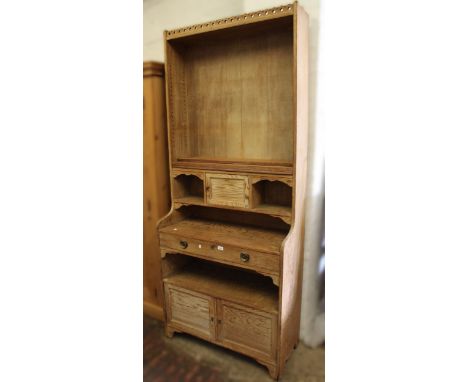 Large one piece Art Nouveau pitch pine open shelf side cabinet with various doors, cubby holes and shelves on bracket feet, 1