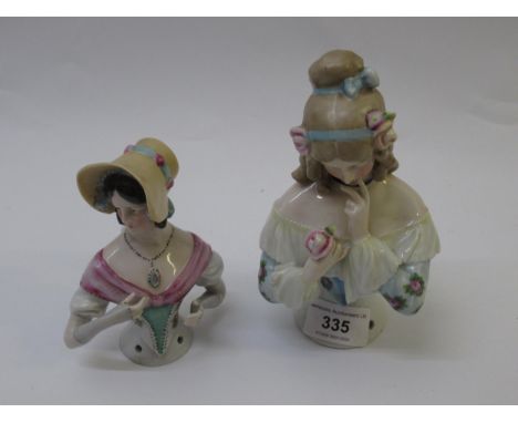 Goebel half doll in the form of a girl with her hair in ringlets studying a rose, 15.5cm high together with another of a girl
