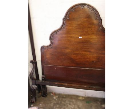 Mahogany double bedstead in 18th Century style, the shaped carved headboard above carved cabriole claw and ball supports, 145