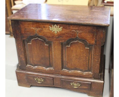 Late 18th / early 19th Century oak coffer, the plank top above a two panelled shaped front with two frieze drawers having swa