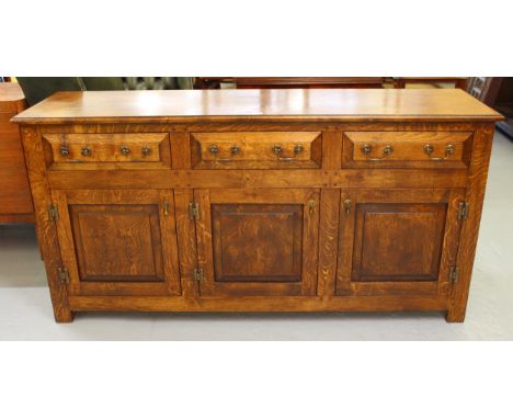 Good quality reproduction dresser base, the moulded top above three drawers and three fielded panel doors with brass H hinges