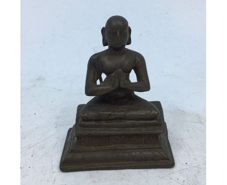 A small Indian bronze figure of a monk. H:6.5cm