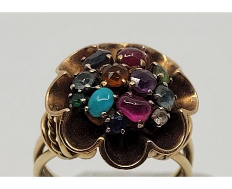 A 9ct. gold and multi-colour mixed gemstone set flower form cluster ring, set various mixed round cut and cabochon gemstones,