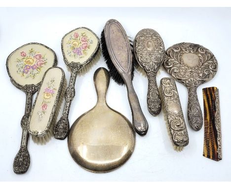 A four piece silver mounted dressing table set, by W I Broadway &amp; Co, Birmingham 1978, repousse decorated in the Victoria