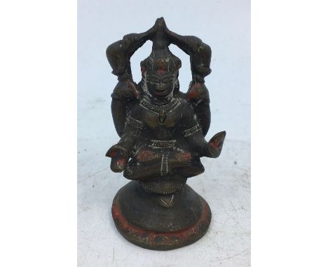A small Indian bronze figure of a deity. H:7.3cm