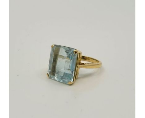 A 18ct. gold and aquamarine cocktail ring, Birmingham 1982, claw set emerald-cut aquamarine, size UK K. (gross weight 6.8g)Co