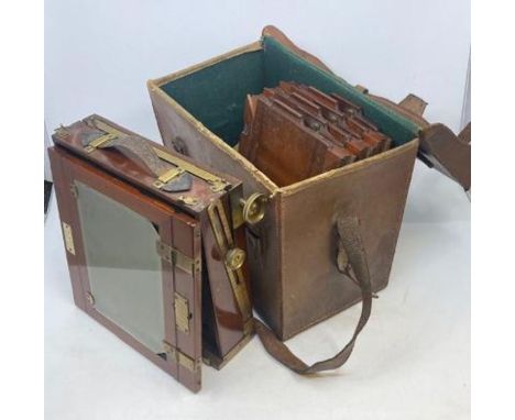 A cased 19th cent wooden box camera complete with lens