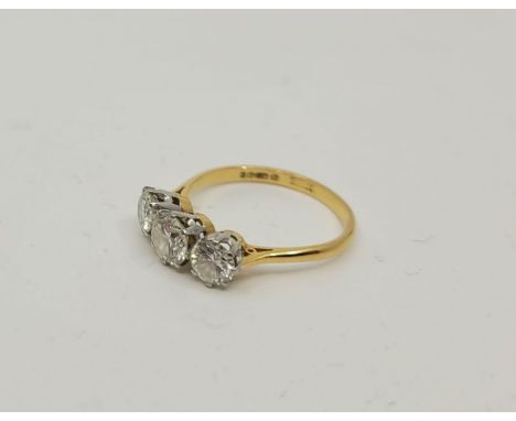 An 18ct. gold three stone diamond ring, London 1975, set three graduated round brilliant cut diamonds (ETDW 2.02 carats), siz