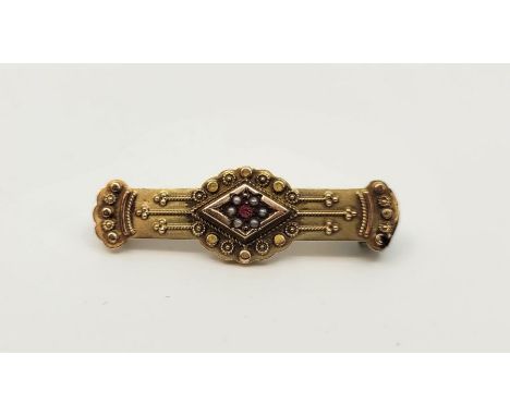 A 9ct. gold, red paste and pearl set brooch,&nbsp;set old-cut red paste to centre bordered by ring of pearls, length 38mm. (g
