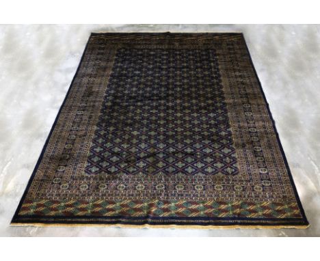 A KASHMIRI WOOL CARPET (365 x 283cm)
Hand knotted wool with a navy field, allover diamond lattice design, featuring intricate