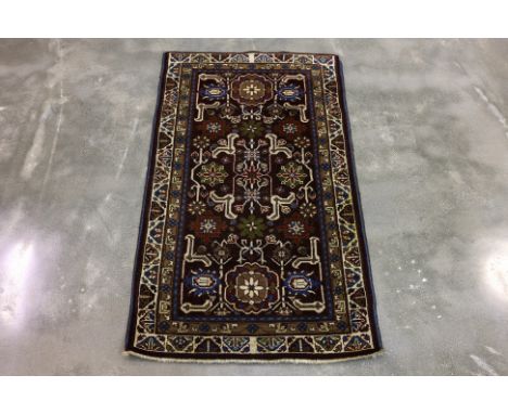 A PERSIAN HAMADAN WOOL RUG (148 x 82cm)
Hand knotted wool pile featuring floral motifs with elongated vine scrolls, set again