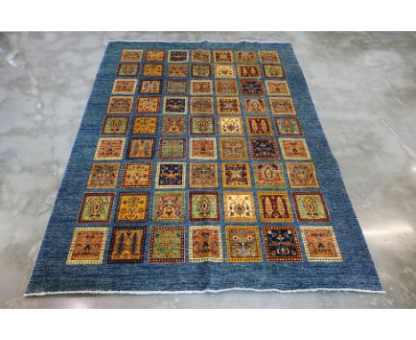 A BAKHTIAR PANELED WOOL CARPET (300 x 240cm)
Hand knotted, the central panelled field featuring varying flowers and foliage
O