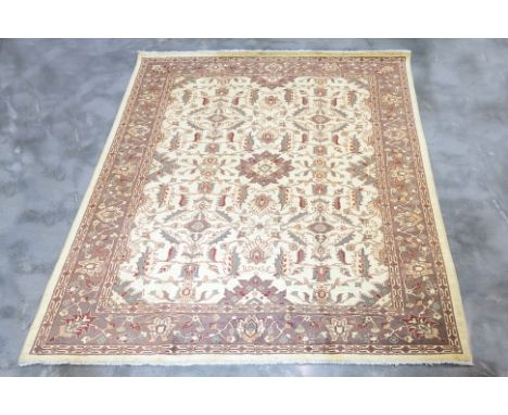 AN OUSHAK WOOL CARPET (300 x 252cm)
Hand knotted wool pile with an ivory field adorned with intricate all-over floral motifs,