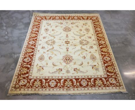 AN AFGHAN SULTANABAD WOOL RUG (250 x 200cm)
Hand knotted wool with a cream field featuring floral and vine motifs, framed by 