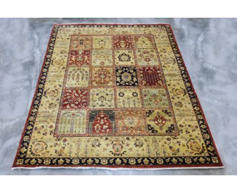 A LARGE MASHAD WOOL CARPET (295 x 240cm)
Hand knotted wool with a cream field, a grid of multi-colored squares featuring intr