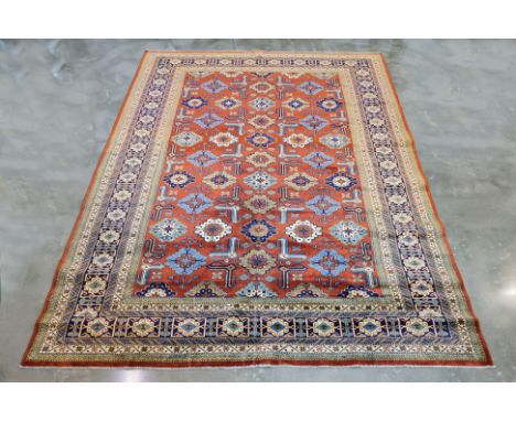 A SUPERFINE SHIRWAN WOOL CARPET (298 x 220cm) Hand knotted wool pile, a terracotta field with geometric medallions in blue, c