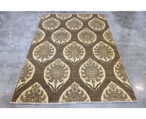 A CONTEMPORARY WOOL CARPET (300 x 200cm)
Hand knotted wool pile with oversized leaf motifs in beige and brown tones
Ownership