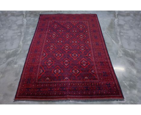 A TURKMAN TRIBAL WOOL CARPET (299 x 203cm)
Hand knotted wool, red ground with central medallions
Ownership Statement: This it