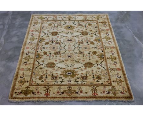A KERMAN WOOL RUG (205 x 176cm)
Thick hand knotted wool pile, with a cream field featuring floral and vine motifs in muted gr