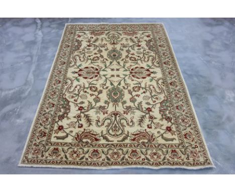 AN AFGHAN ZIEGLER WOOL RUG (277 x 186cm)
Hand knotted wool pile with a cream field with flowers and scrolling foliage
Ownersh
