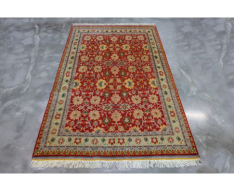 AN ANTIQUE PERSIAN FERAHAN WOOL CARPET (310 x 191cm)
Hand knotted wool, burnt siena field with all over floral motifs
Ownersh
