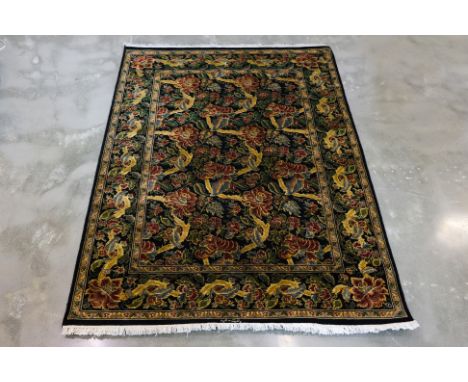 A PAK PERSIAN WOOL RUG (220 x 155cm)
Hand knotted wool pile, finely knotted with an allover floral pattern, signed at the bas