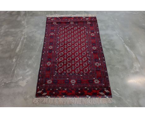 A BOKHARA WOOL RUG (195 x 107cm)
Hand knotted wool, red field filled with four rows of guls
Ownership Statement: This item is
