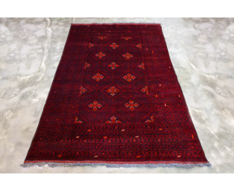 A TURKMEN TRIBAL WOOL CARPET (305 x 198cm)
Hand knotted wool, red field with tribal and geometric patterns throughout
Ownersh